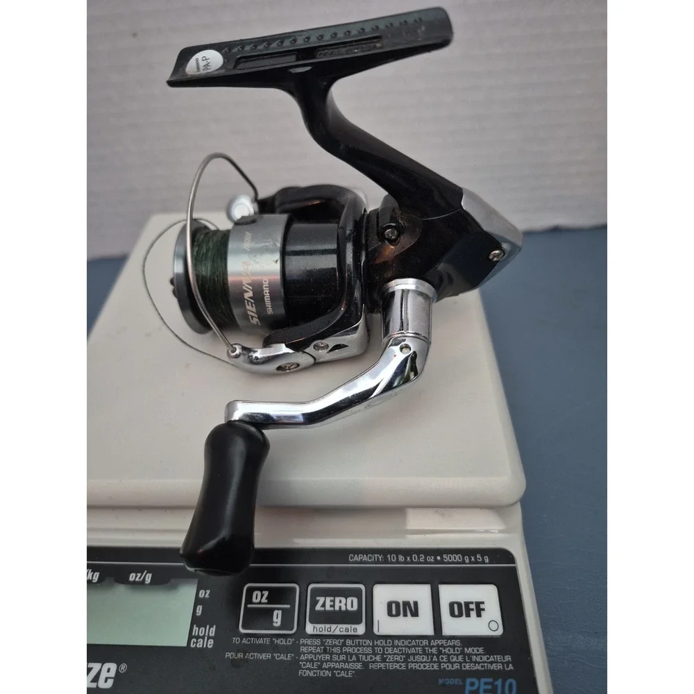 SHIMANO SIENNA 1000 FE SPINNIG REEL..LOOKS NEW BUT SELLING AS USED